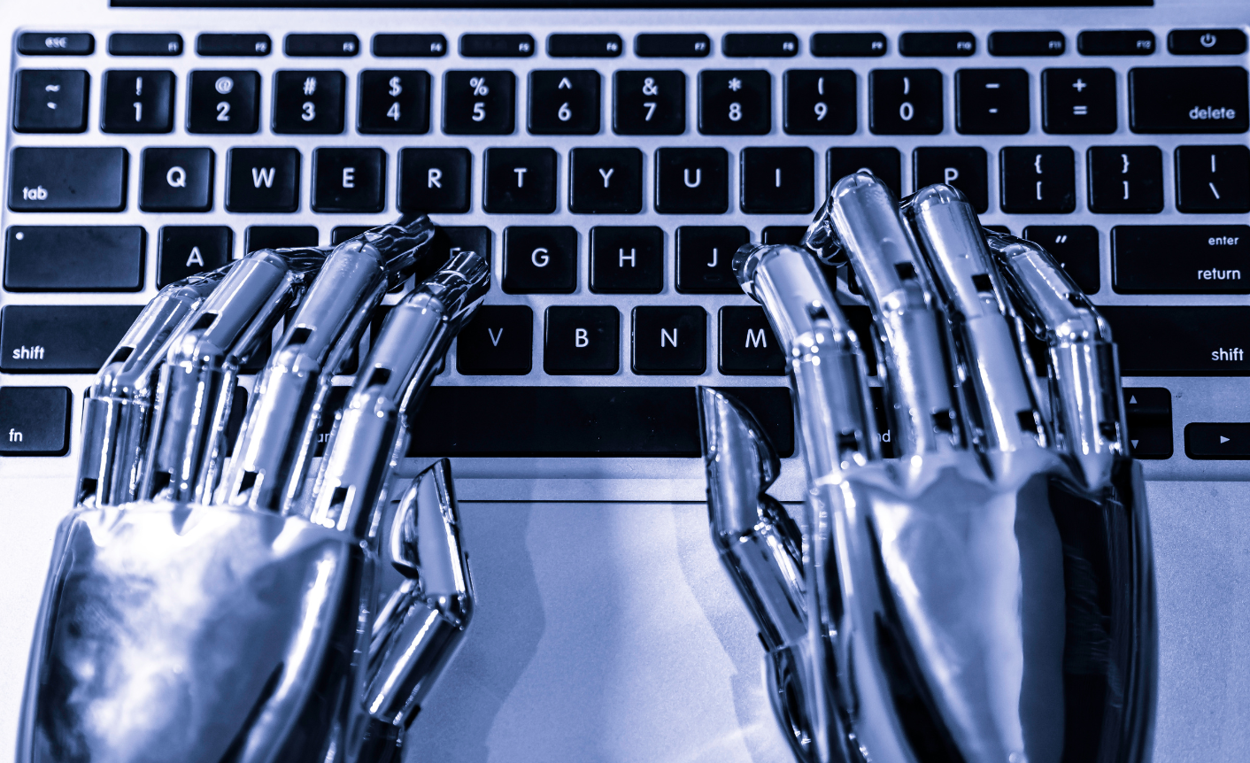 Robotic hands typing on a keyboard.