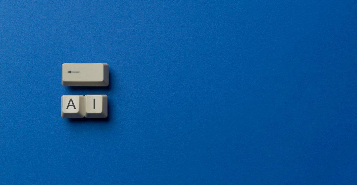 On a dark blue background are three old-fashioned keyboard keys. One with an arrow pointing backwards and the other two with the letters "A" and "I" on them.