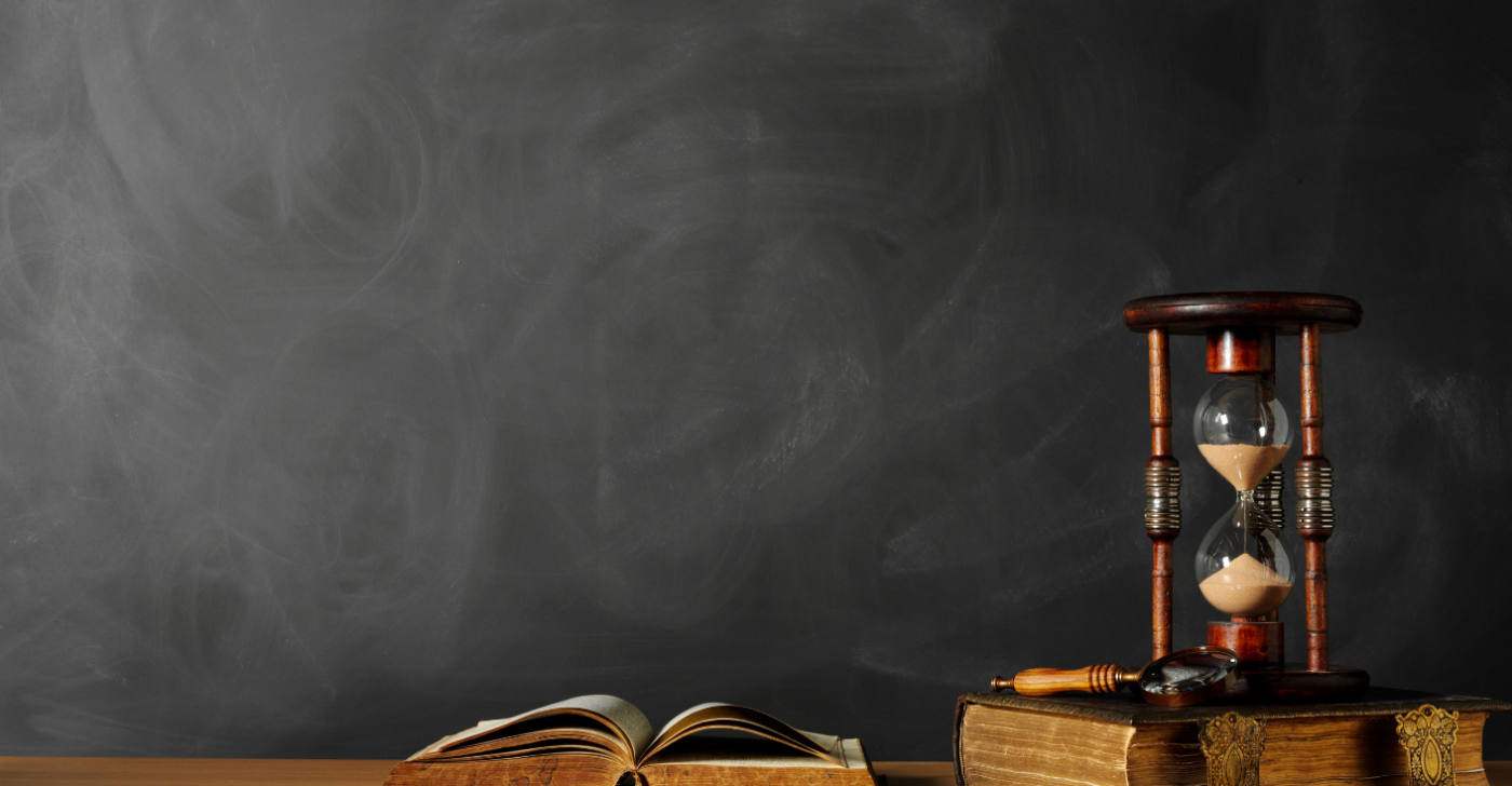 On a black background is a sand timer and some old books to reference the need organizations have for a content refresh.